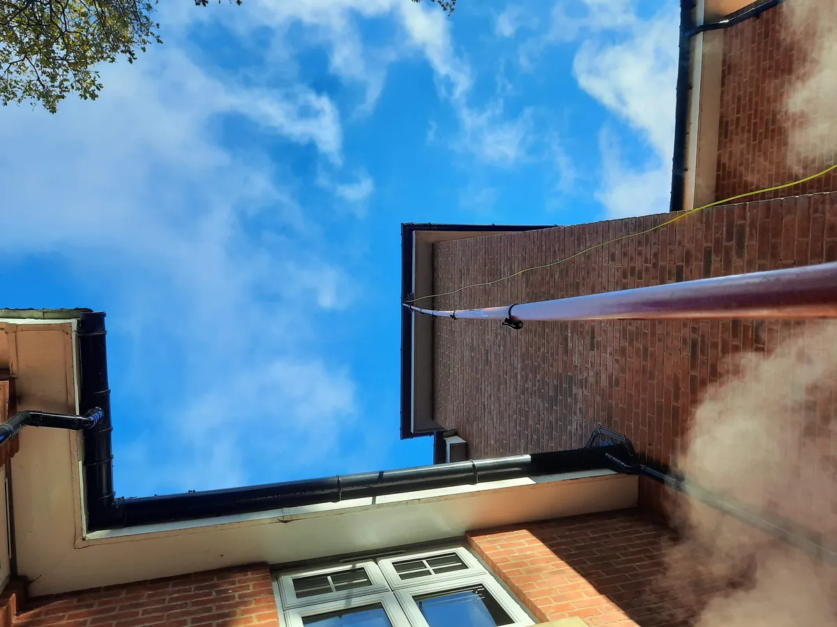 Gutter cleaning job showing cleared gutters and debris removal