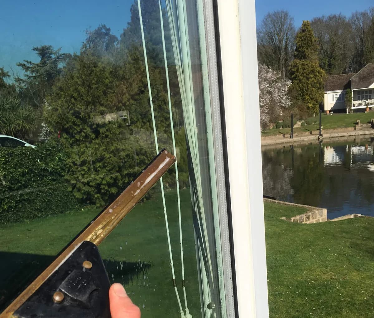 Window cleaning on a house in Surrey using pure water system